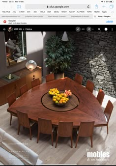 an image of a dining room table with fruit on the top and chairs around it