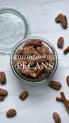 cinnamon sugar pecans in a glass bowl on a marble surface with the words cinnamon sugar pecans