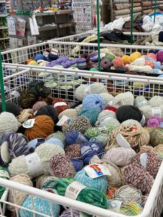 many balls of yarn are in baskets on the floor