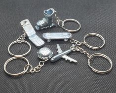 a bunch of keys that are sitting on a table together, with one keychain attached to the other