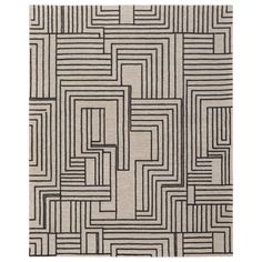 an abstract rug with black and white lines on the ground, in front of a white background