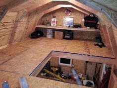 the inside of a building that is being built with wood and plywood on the floor