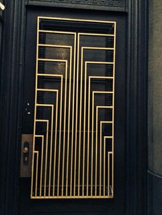 a black door with gold bars on it