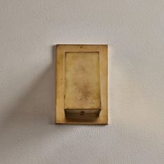 a square light switch mounted to the side of a wall