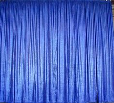 a blue curtain is hanging on the wall