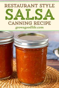 two jars filled with salsa sitting on top of a woven place mat next to a canister