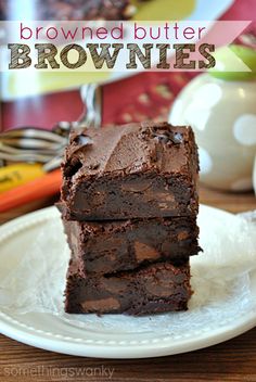 chocolate brownies stacked on top of each other on a white plate with the words, browned butter brownies