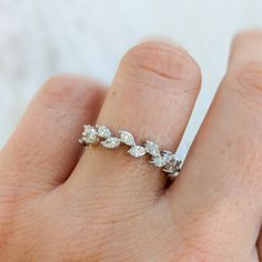 a woman's hand with a diamond ring on it