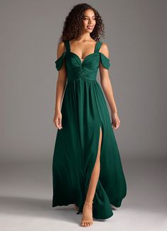 a woman in a long green dress posing for the camera