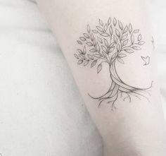 a small tree tattoo on the arm