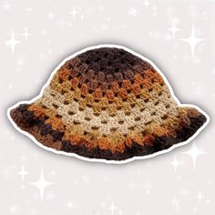 a crocheted hat is shown on a white background and stars are in the sky