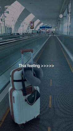 a suitcase sitting on the ground in an airport with text that reads, this feeling