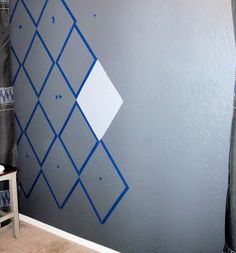 the wall is painted with blue and white designs