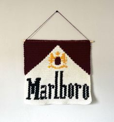 The Marlboro crochet pattern is made for advanced beginners to intermediate crochet artists. I highly suggest some prior knowledge of basic crochet techniques (single crochet, turning the work, etc). This pattern includes helpful instructions to start, a color block pattern, and a graph pattern as well. It also includes instructions on how to finish off with a border (if you want to) and mounting the tapestry as well. Just a note, this is written in US terminology, but you just need to know one Tapestry Crochet Patterns Simple, Free Tapestry Crochet Patterns, Simple Tapestry Crochet, Crochet Tapestry Pattern, Simple Tapestry, Crochet Wall Hanging, Tapestry Pattern, Color Block Pattern, Crochet Wall Hangings