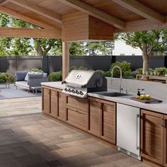 an outdoor kitchen with wood cabinets and stainless steel appliances