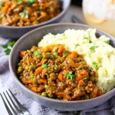 two bowls filled with mashed potatoes and meat