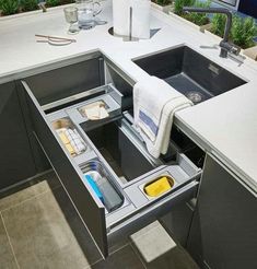 an open drawer in the middle of a kitchen counter