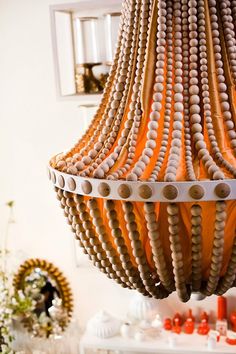 a chandelier made out of wooden beads hanging from the ceiling