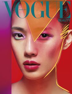 a woman with bright makeup on the cover of a magazine, featuring an image of her face