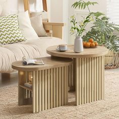 two wooden tables sitting next to each other in a living room