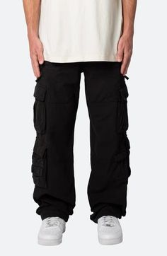 The relaxed fit of these all-cotton pants lets you move with ease all day long, while the multitude of cargo pockets keep all your essentials close at hand. 32" inseam; 9 1/2" leg opening; 11 3/4" front rise Zip fly with button closure; drawstring waist Front slant pockets; front zip pockets; cargo flap-patch pockets; back patch pockets 100% cotton Machine wash, tumble dry Imported Black Combat Cargo Jeans, Black Combat Straight Leg Pants, Black Combat Pants With Straight Leg, Baggy Combat Cotton Cargo Pants, Black Combat Cargo Jeans With Side Pockets, Baggy Cotton Combat Cargo Pants, Combat Style Relaxed Fit Bottoms For Streetwear, Combat Parachute Pants With Side Pockets, Relaxed Fit Cotton Pants With Functional Pockets