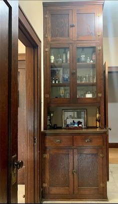 a wooden cabinet with glass doors in a room