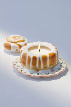 two small candles sitting on top of a plate