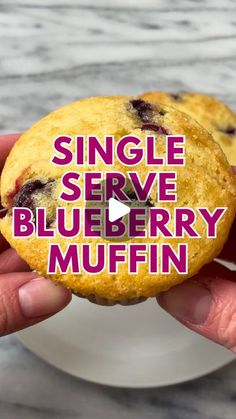 a hand holding a blueberry muffin with the words, single serve blueberry muffin