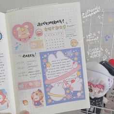 someone is holding an open planner book with stickers on it and there are other items in the background