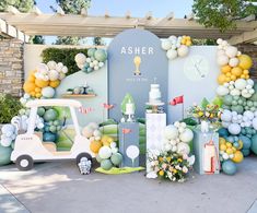 an assortment of desserts and decorations on display in front of a sign that says asher