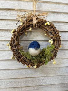 a blue bird sitting on top of a wreath