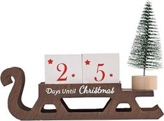 a wooden sleigh with two days until christmas and a small tree on top