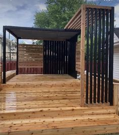 a wooden deck with a gazebo on the top and stairs leading up to it