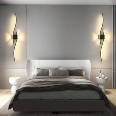 a bed with two lights on the wall above it