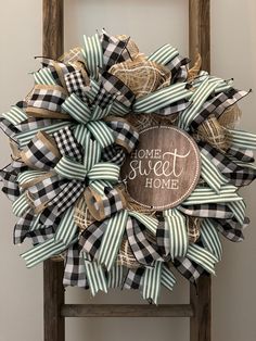 a black and white wreath with the words home sweet on it