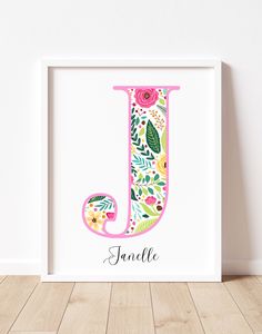 the letter j is decorated with flowers and leaves in pink, green, yellow, and blue