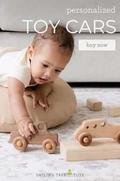 a baby playing with wooden toys on the floor