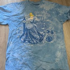 a blue t - shirt with an image of a princess on it