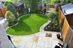 a small backyard with grass in the middle