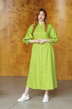 Calf-length dress in linen. Stand collar, buttons at front, long wide ruffled at bottom sleeves with narrow elastic at cuffs, which allows to raise the sleeve to 3/4 length. Pockets in side seams. Gently flared skirt. Unlined. FEATURES Name: Tacoma linen dress Color in the picture: citron Decor: plain Material: linen Length: ankle-length Clasp: buttons Collar: stand-up collar Sleeve length: long sleeve Sleeve style: trumpet sleeve Fit: relaxed fit Features: with pockets, with ruffles Season: summer Spring Daywear Maxi Linen Dress, Long Sleeve Maxi Dress With Button Cuffs For Daywear, Spring Linen Maxi Dress, Green Linen Spring Dress For Daywear, Spring Green Linen Daywear Dress, Spring Green Linen Dress For Daywear, Spring Linen Buttoned Dress, Cotton Long Sleeve Maxi Dress With Buttons, Long Sleeve Cotton Maxi Dress With Buttons