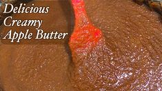 a close up of a pie with chocolate icing on it and the words delicious creamy apple butter