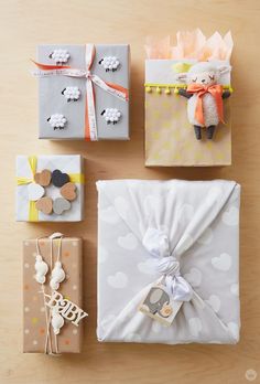 four wrapped gift boxes with sheeps on them