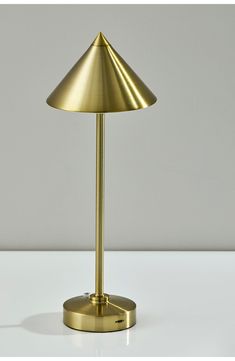 a gold table lamp on a white surface