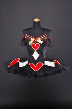 a black and red dress with hearts on it