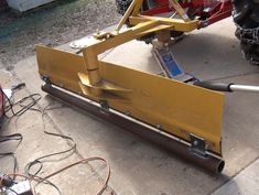 the back end of a yellow vehicle being worked on