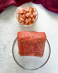 raw meat and diced vegetables in glass bowl on counter top next to red towel