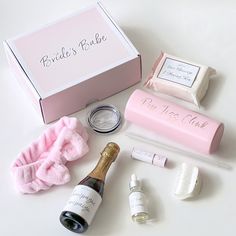 the contents of a personal care box are laid out on a white surface, including an empty bottle