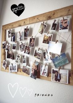 a wooden frame with pictures hanging on it and the word friends written in front of it