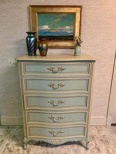 an antique dresser painted in blue and gold