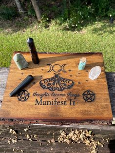 "OMG how GORGEOUS this altar/manifestation board!? It's pretty large at 12.5\" x 9\". It's been engraved with a triple moon, mystic moth, two pentagrams and reads \"thoughts become things, MANIFEST IT\". It has been sealed with a sparkling glaze that shimmers in the light. (I tried to capture this in the video, but the video does not do it justice!) Photo props not included, board only. It would also make a nice display piece in your kitchen or anywhere else in your home. Price includes FREE pri Things To Do With A Laser Engraver, Outdoor Altar Witch, Witches Altar Ideas, Wiccan Decor Diy, Witchcraft Altar Ideas, Altar Ideas Witchcraft, Pagan Altar Inspiration, Witch Altar Aesthetic, Witch Shop Aesthetic